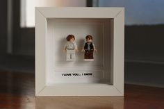 two legos in a shadow box with the words i love you, i know