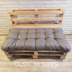 a bench made out of wooden pallets and cushions