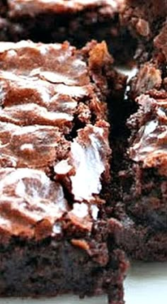 some brownies are cut into squares on a white plate and ready to be eaten