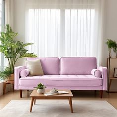 a living room with a pink couch and coffee table in front of a large window