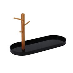 a black tray with a wooden cross on it and a metal holder in the shape of a tree