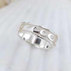 Crafted in Sterling Silver, these Marianas Wave rings let you carry your love of the ocean on your hand. PLEASE NOTE: 7mm wide bands are currently only available in sizes 9-12 and the 4.6mm bands are only available in sizes 6-9. Thanks! Large Band Dimensions: Approximately 7mm wide and 2.25mm thick at a size 10 though this may change slightly as the band is increased or decreased in ring size. Small Band Dimensions: Approximately 4.6mm wide and 2.0mm thick at a size 6 though this may change slig Silver Ocean-inspired Jewelry For Promise Ring, Silver Ocean-inspired Promise Ring, Ocean-inspired Round Ring For Anniversary, Wave Rings, Small Band, Wave Ring, Wide Bands, The 4, The Ocean