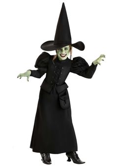 a woman in a witch costume with her arms outstretched and hands out to the side