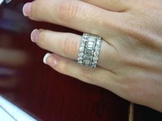 a woman's hand with two rings on it