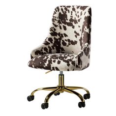 an office chair with a cow print upholstered on it's back and wheels