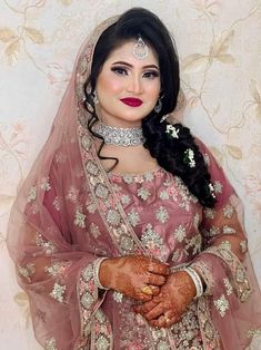 a woman in a bridal outfit with her hands on her chest and arms crossed