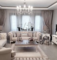 a living room filled with furniture and a chandelier