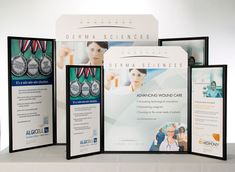 three different awards are displayed in front of an advertisement for derma science's annual conference