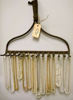 a coat rack with many necklaces hanging from it