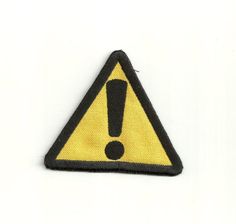 a yellow and black warning sign on a white background