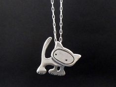 Sterling Silver Cat NecklaceThis cat is ready to rock! He measures an inch tall and is handmade using solid sterling silver. The charm comes with a 16 - 20 inch adjustable sterling silver chain. Each item comes in a cute box ready for gift giving, without a receipt. If you'd like to include a gift message, let me know at checkout. Items are shipped USPS First Class. Shipping upgrades available at checkout. Punk Cat, Silver Cat Pendant, Cat Necklace Silver, Sterling Silver Charm Necklace, Sterling Silver Cat, Cat Pendant, Charm Necklace Silver, Silver Cat, Cat Pendants