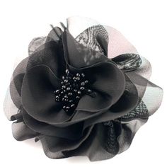 a black flower with some pearls on it