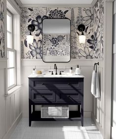 a bathroom with two sinks and a large mirror on the wall next to it is decorated in black and white flowers