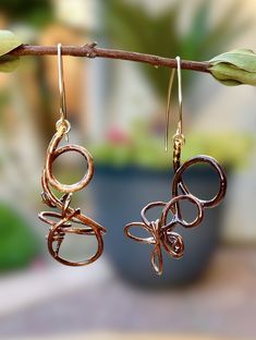 Featuring wild river grapevine tendrils, this pair of earrings is adorned with 24 kt. gold leaf accents, suspended from 14 kt. gold-filled wire dangles. So light and airy on your ears! Grapevine Tendrils are another masterpiece of nature! No two are ever the same, yet they are always in harmony. This is my first collection honoring their magnificent beauty. I create each pair with great thought and many hours of additional embellishments. It has taken over a year to develop this concept.  *Included: Earrings are attached to a wood earring card, placed in a sheer silk organza and grey linen pouch, then placed inside a Poplar bentwood gift box with an enamel flower button closure.  For your Gift Box, Please use the dropdown menu to pick the enamel flower color of your choice! Earrings length Whimsical Gold Wire Wrapped Earrings, Nature-inspired Gold Wire Wrapped Earrings, Hypoallergenic Dangle Earrings With Copper Wire, Linen Pouch, Wood Earring, Flower Button, Earring Card, Rustic Boho, Earring Cards