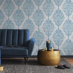 a living room with blue couches and wallpaper