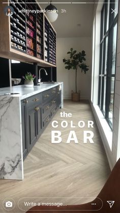 the color bar in this kitchen is white and grey with marble countertops, cabinets, and drawers