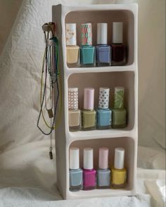 the shelf is filled with different nail polishes