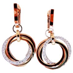 Rolling Rings circle loop earrings. The Modern Dangle. .52cts of natural round diamonds: G-color, Vs-2 clarity. 14kt. white / yellow / rose gold 8.7 grams. Earrings measure: 1.25 inch long .65 inch wide diameter on each ring Comfortable Lever snap on the mini hoop. $5,000 Appraisal Certificate to accompany Rolling Ring, Loop Earrings, Circle Ring, Yellow Roses, Round Diamonds, Natural Diamonds, Jewelry Earrings Dangle, Dangle Earrings, Jewelry Earrings