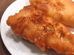 two fried food items on a white plate