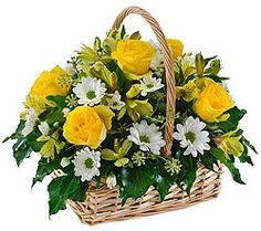 a basket filled with yellow and white flowers