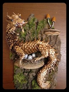 an image of a dragon made out of pine cones and other things on a table