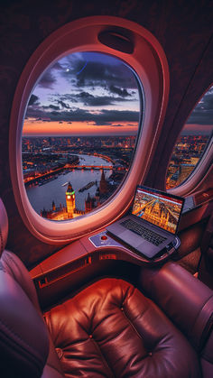 A luxurious business class seat on a plane overlooks London's illuminated Big Ben and River Thames at sunset, with a laptop on the table reflecting the vibrant scene. Europe Luxury Aesthetic, Travelling For Work Aesthetic, Travel Destinations Aesthetic, Flying Business Class Aesthetic, New Business Aesthetic, Remote Work Aesthetic Travel, New Experiences Aesthetic, Luxury Lifestyle Photography, Work Travel Aesthetic