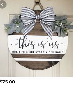 this is us our life story our home door hanger with ribbon and flowers on it