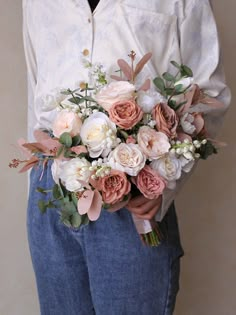 a person holding a bouquet of flowers in their hands