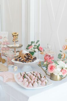 a table topped with lots of desserts and pastries