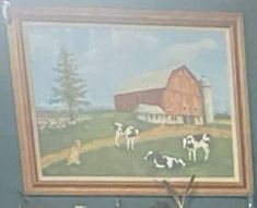 there is a painting on the wall with cows in front of it and a barn