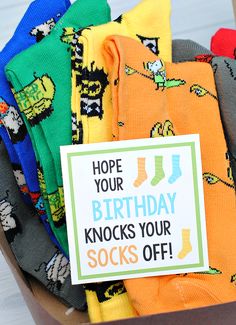 a box full of socks with a sign saying, hope your birthday knocks your socks off