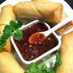 a white plate topped with food and dipping sauce