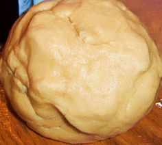 a ball of dough sitting on top of a wooden table