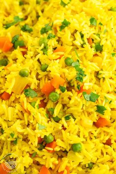 yellow rice with peas and carrots in a bowl