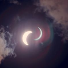 the eclipse between two crescents is seen through clouds