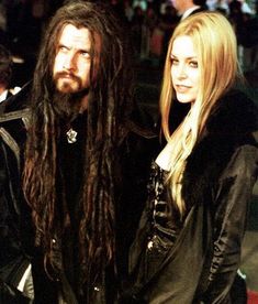 two people standing next to each other with long hair