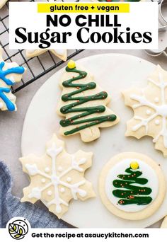 decorated christmas cookies on a cooling rack with cookie cutters and other holiday treats nearby