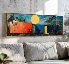 a painting hanging on the wall above a couch