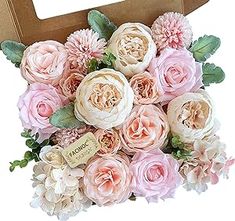 a cardboard box filled with pink and white flowers