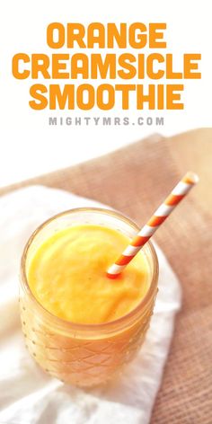 orange creamsicle smoothie in a mason jar with a striped straw