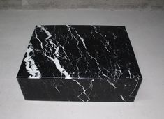 a black and white marble box sitting on the ground