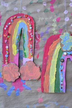 the letters are made out of paper and decorated with rainbows, hearts, and beads