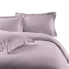 an image of a bed with purple sheets and pillowcases on top of it