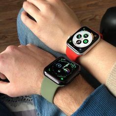 two people wearing apple watches on their wrist