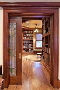 an open door leading to a library filled with books