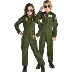 two children in green flight suits standing next to each other with their hands on their hipss