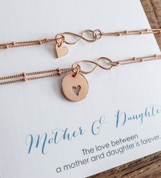 Mother and daughter infinity bracelets sets available in 4 different finishes. the listing includes Two bracelets featuring a cut out heart disc for mother and tiny heart charms for daughter. small heart charm bracelet 6-7'' Cutout heart charm bracelet 6.5-7.5'' *Please let me know if you need diff. chain length. no extra fee up to 8'' rose gold version is made of rose gold filled chain, rose gold plated charms Please follow us on instagram for promotions and discount offers https://www.instagra Adoption Jewelry, Minimalist Wedding Jewelry, Bracelets Sets, Infinity Bracelets, Silver Bridal Jewellery, Mother Daughter Jewelry, Mother Daughter Bracelets, Heart Disc, Wedding Gifts For Parents