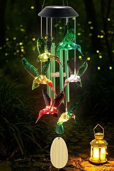 a wind chime that is lit up with colorful lights and hummings on it