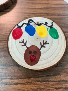 a piece of wood that has been decorated with christmas lights and a reindeer's head