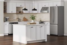 a kitchen with white cabinets and an island in front of the stove, refrigerator and microwave